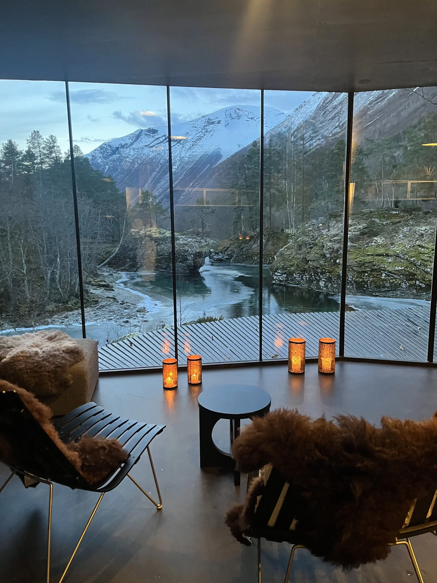 Mountain landscape through modern glass architecture